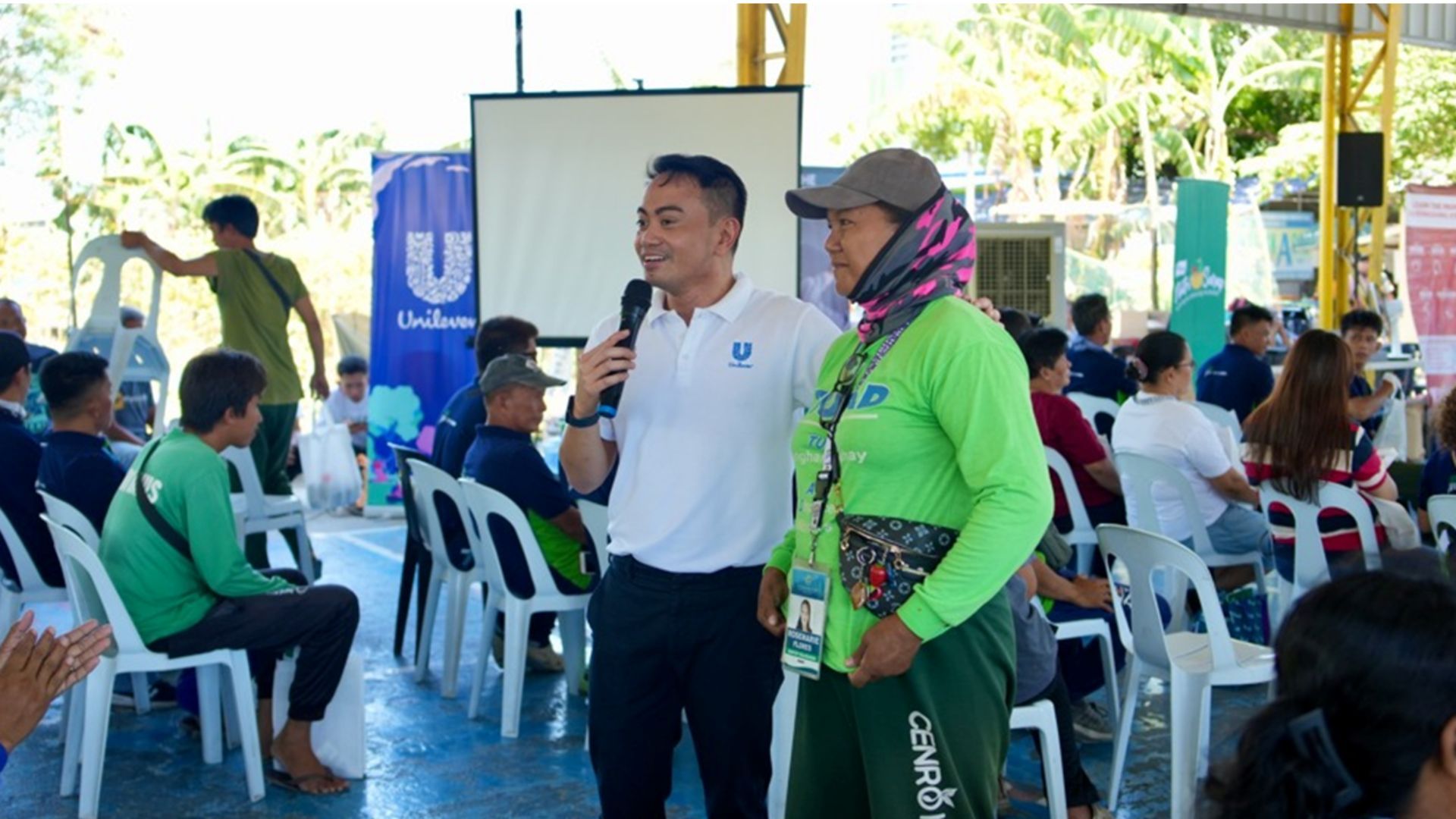 A Unilever team member engaging with a waste worker