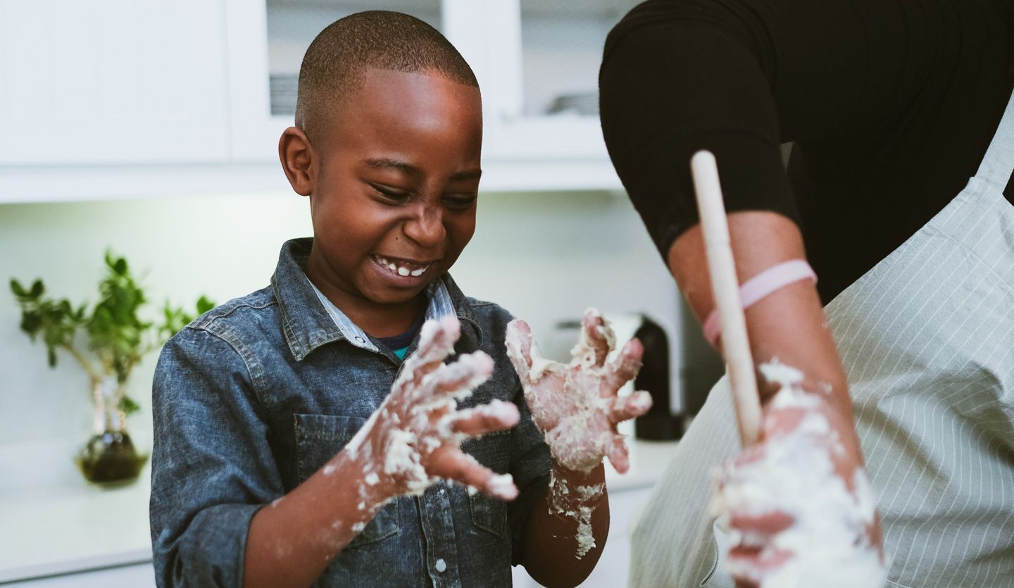 Boy cooking with sticky fingers. Family meal plans and activities were key F&R initiatives during lockdown.