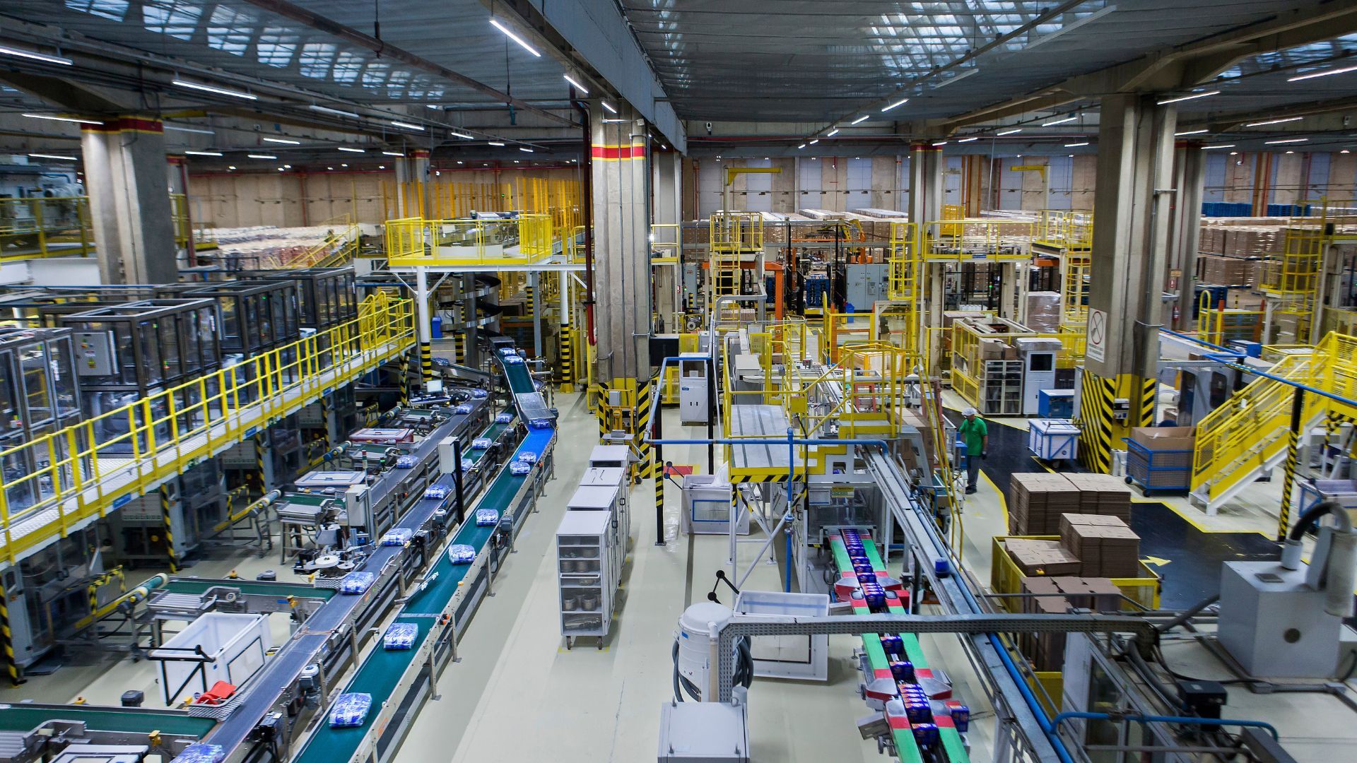 Image of a factory production line, with products on conveyer belts.