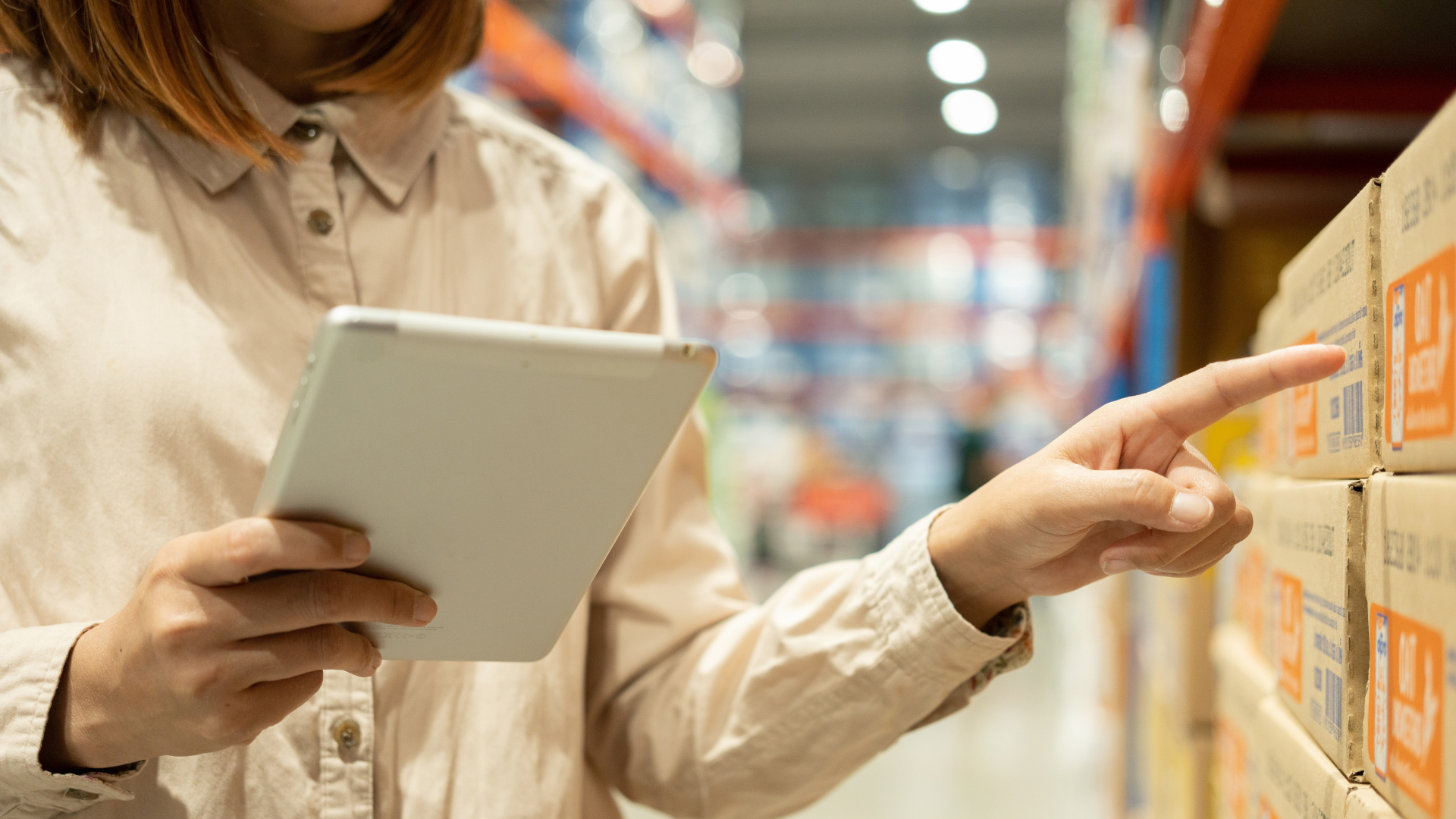 A person’s hand tapping their mobile phone screen to open an app and place a retail goods order