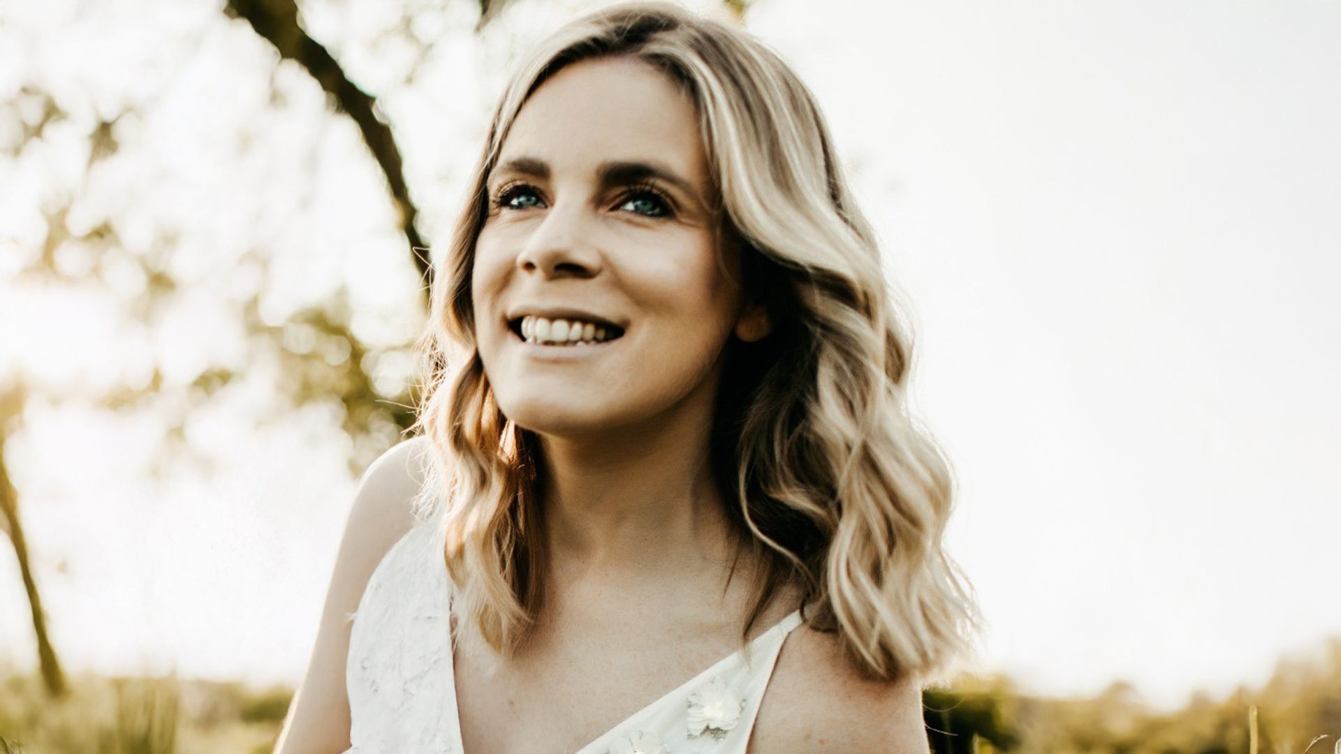 A photo of Em Heath, Global Engagement Director for Rexona. Em is a white woman with blonde hair, smiling at the camera.