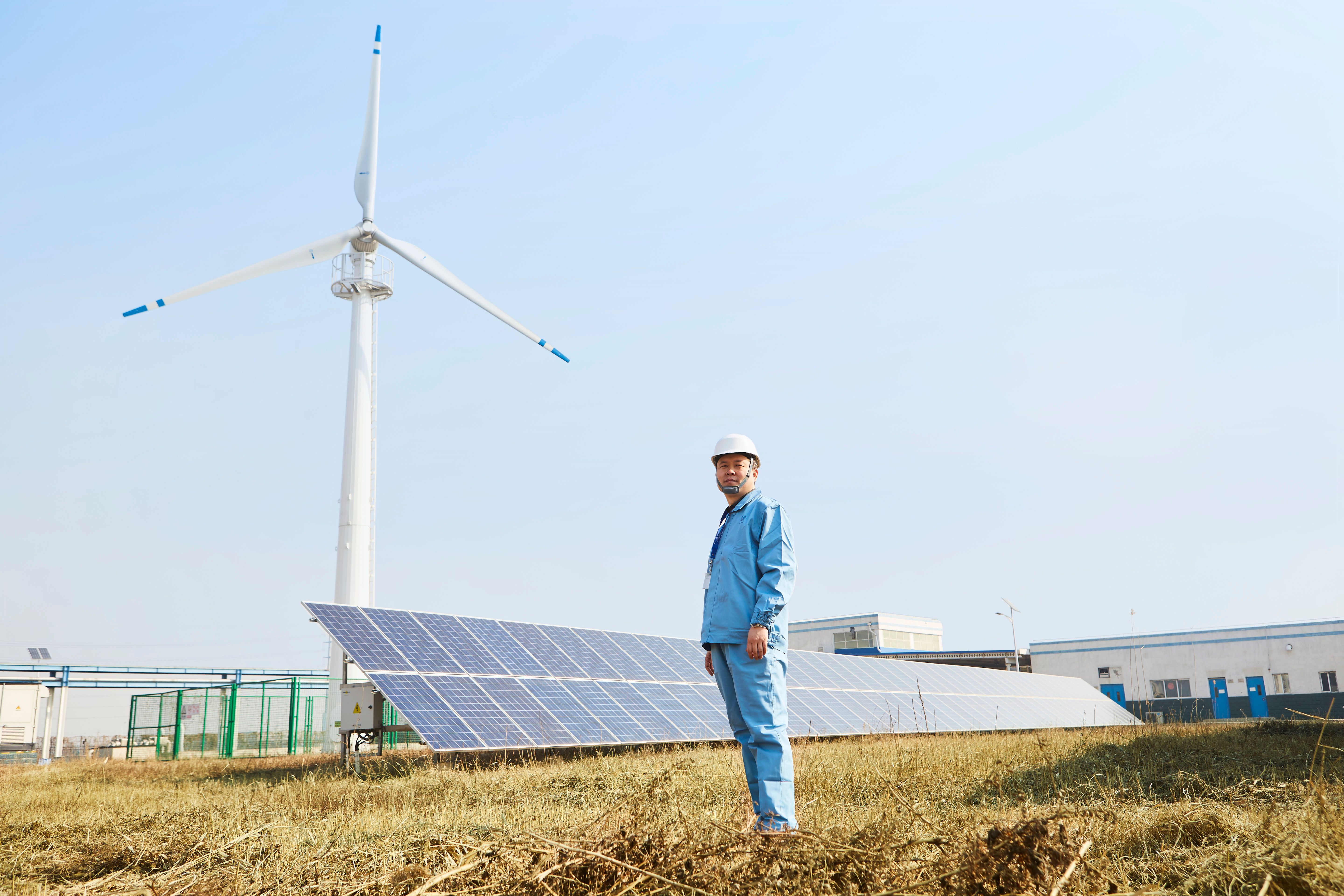 Man stood in front of solar panels