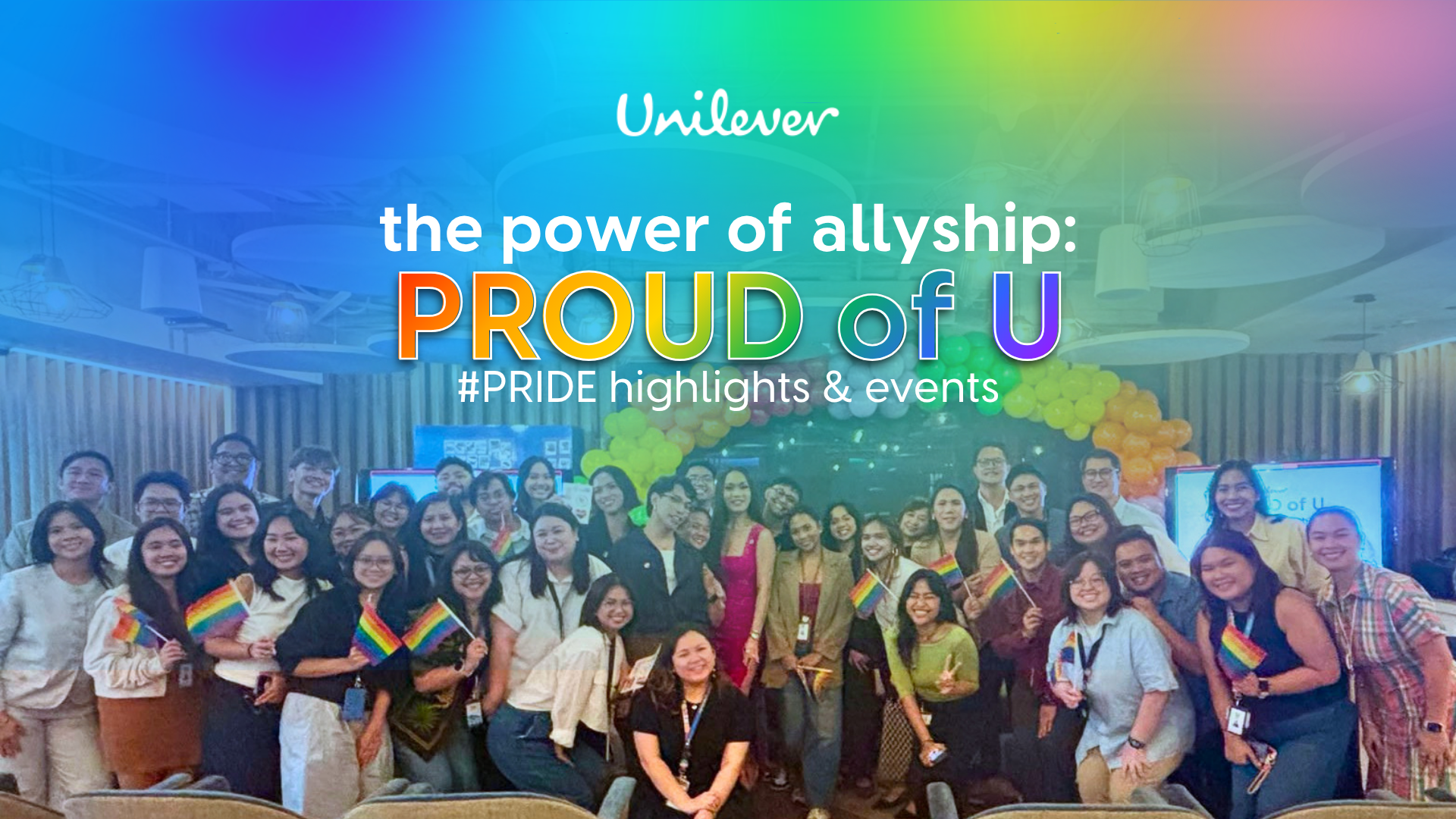 Group photo of Unilever employees celebrating Pride with rainbow flags and a balloon arch, featured under the banner “The Power of Allyship: Proud of U.”