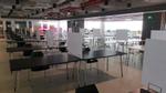 The office canteen where tables and chair have been separated with dividers between them
