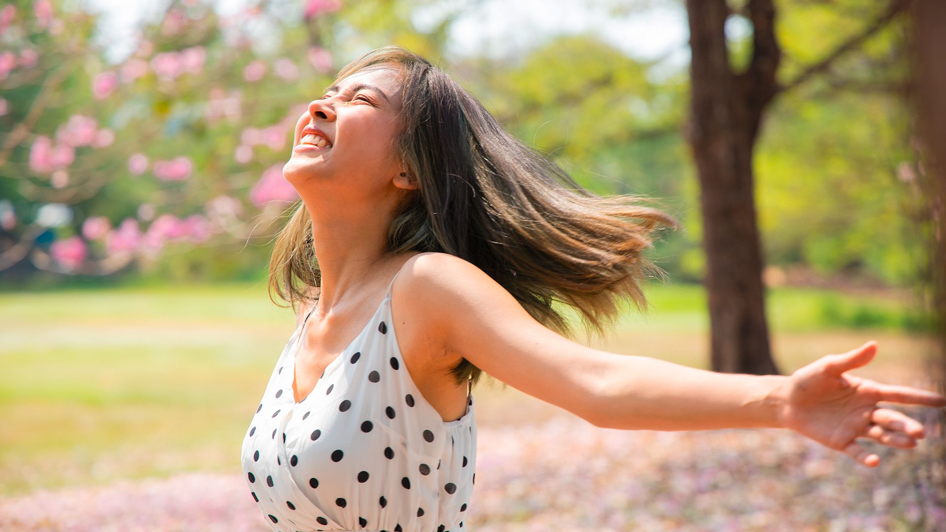 A girl running through a blossom tree