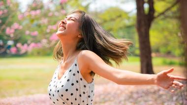 A girl running through a blossom tree